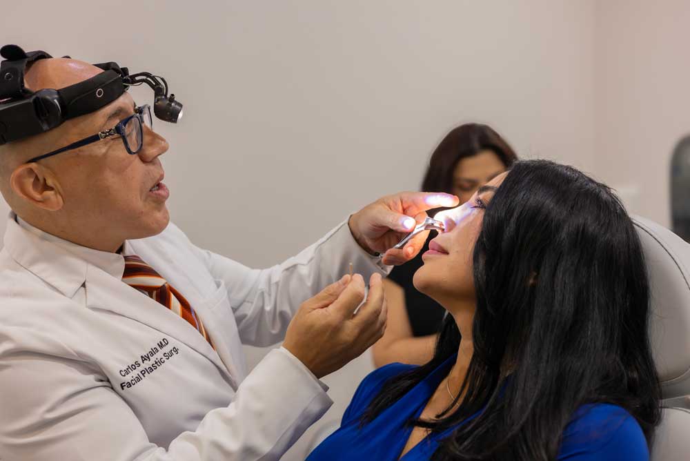 patient receiving nose treatment from Dr. Ayala